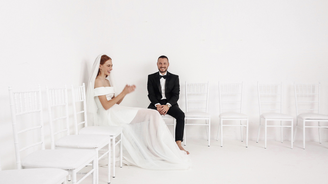 designer-mihano-momosa-sitting-on-white-chairs-with-female-model-in-bridal-collection